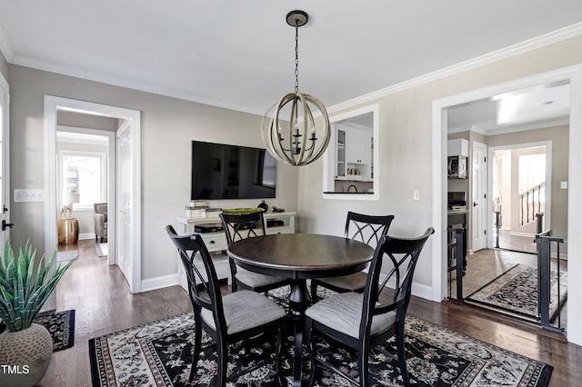 627 New Rd, Raleigh, NC 27608 - dining space with a chandelier, dark wood-type flooring, and ornamental molding