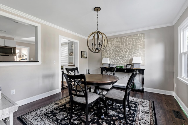 627 New Rd, Raleigh, NC 27608 - dining space with a chandelier, dark wood-style floors, and crown molding