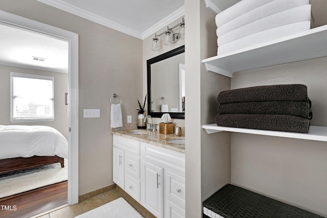 627 New Rd, Raleigh, NC 27608 - ensuite bathroom with double vanity, crown molding, and tile patterned floors