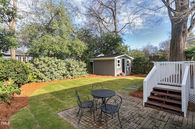627 New Rd, Raleigh, NC 27608 - view of green lawn with a patio, a wooden deck, a shed, and outdoor dining area