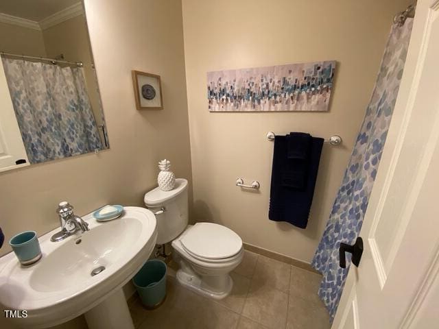 627 New Rd, Raleigh, NC 27608 - full bath featuring ornamental molding, tile patterned flooring, and a shower with shower curtain