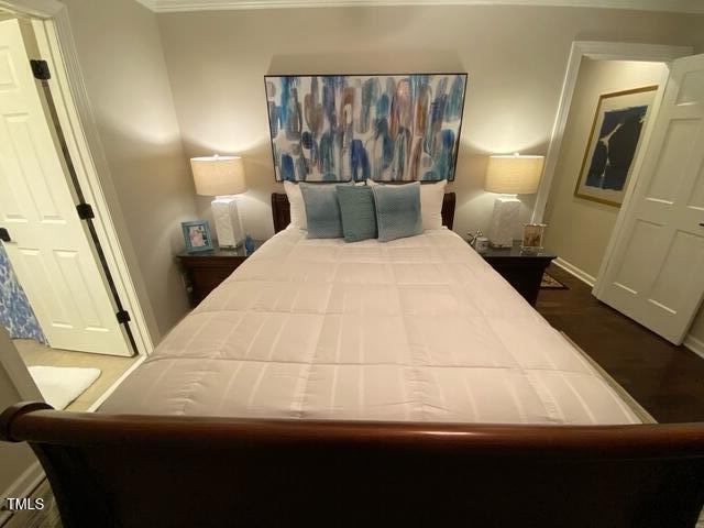 627 New Rd, Raleigh, NC 27608 - bedroom with crown molding and wood finished floors