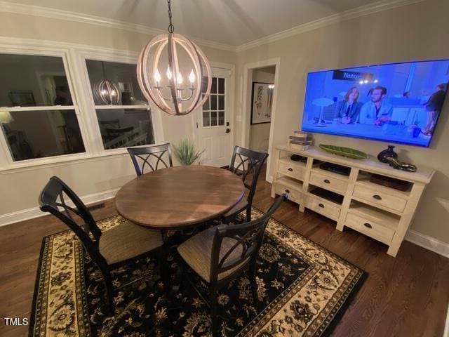 627 New Rd, Raleigh, NC 27608 - dining room with a chandelier, dark wood-style floors, and ornamental molding