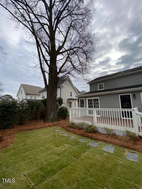 627 New Rd, Raleigh, NC 27608 - view of grassy yard with a wooden deck