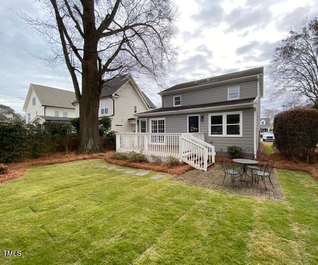 627 New Rd, Raleigh, NC 27608 - rear view of property featuring a wooden deck, a lawn, and a patio area