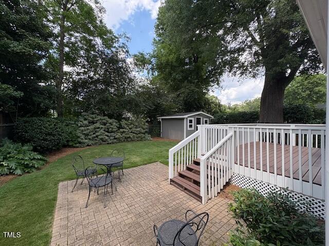 627 New Rd, Raleigh, NC 27608 - view of patio / terrace featuring a wooden deck and an outbuilding