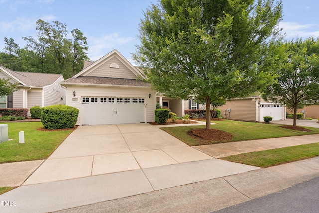 1104 Gaston Manor Dr, Durham, NC 27703 - view of front facade with a front lawn, a garage, and driveway