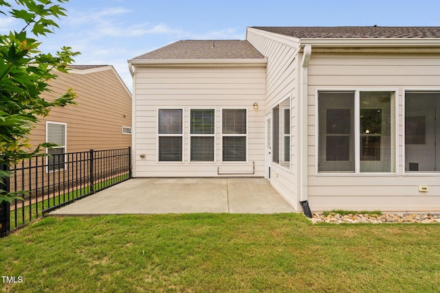 1104 Gaston Manor Dr, Durham, NC 27703 - back of property featuring a patio and a shingled roof