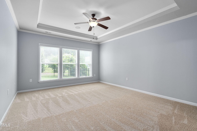 1104 Gaston Manor Dr, Durham, NC 27703 - spare room featuring a raised ceiling, crown molding, light colored carpet, and a ceiling fan