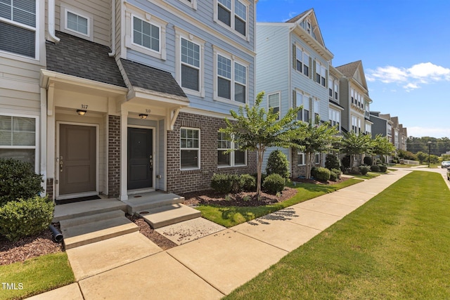 319 Great Northern Sta, Apex, NC 27502 - doorway to property with brick siding and a yard