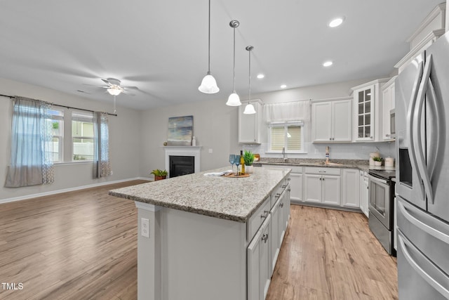 119 Yadkin St, Clayton, NC 27520 - kitchen with appliances with stainless steel finishes, a center island, plenty of natural light, light wood-type flooring, and recessed lighting