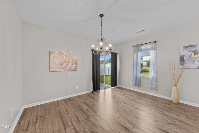 119 Yadkin St, Clayton, NC 27520 - spare room featuring a chandelier and wood finished floors