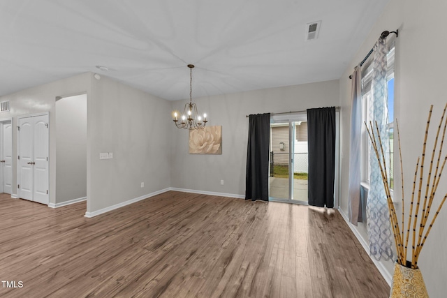 119 Yadkin St, Clayton, NC 27520 - unfurnished room featuring wood finished floors and a chandelier