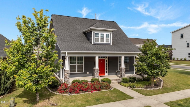 2057 Big Falls Dr, Wendell, NC 27591 - craftsman house featuring a porch, a front yard, roof with shingles, and stone siding