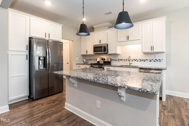 9 Moss Side Ter, Durham, NC 27703 - kitchen featuring appliances with stainless steel finishes, backsplash, dark wood-style flooring, and white cabinets