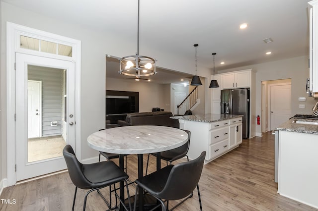 9 Moss Side Ter, Durham, NC 27703 - dining room featuring light wood-style floors, stairs, a chandelier, and recessed lighting