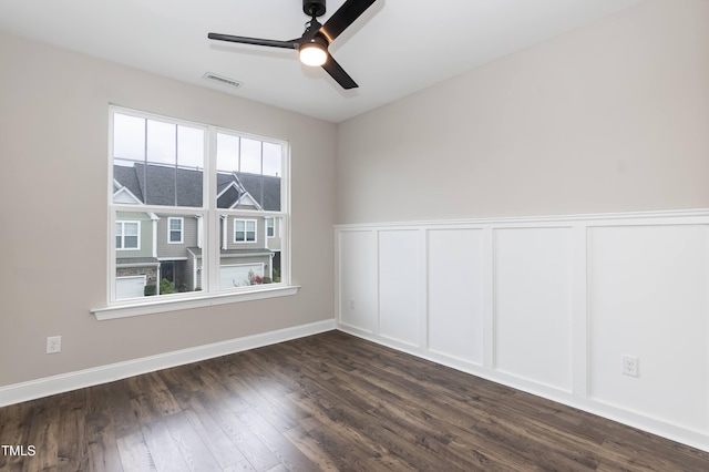 9 Moss Side Ter, Durham, NC 27703 - spare room featuring a ceiling fan, dark wood-type flooring, a wainscoted wall, and a decorative wall