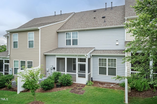 9 Moss Side Ter, Durham, NC 27703 - back of property with a sunroom, a lawn, and roof with shingles
