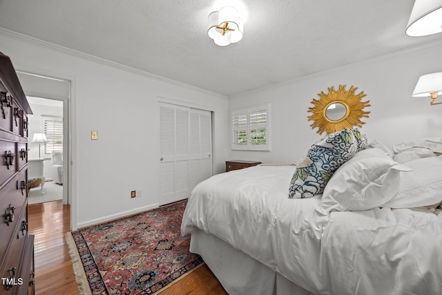 926 Wimbleton Dr, Raleigh, NC 27609 - bedroom with crown molding, a closet, and wood finished floors
