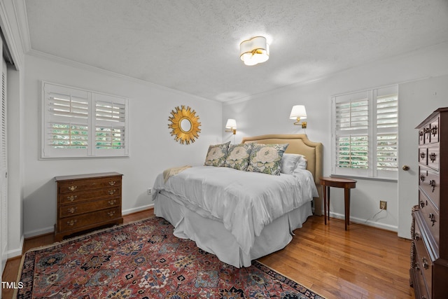 926 Wimbleton Dr, Raleigh, NC 27609 - bedroom with wood finished floors, ornamental molding, and a textured ceiling