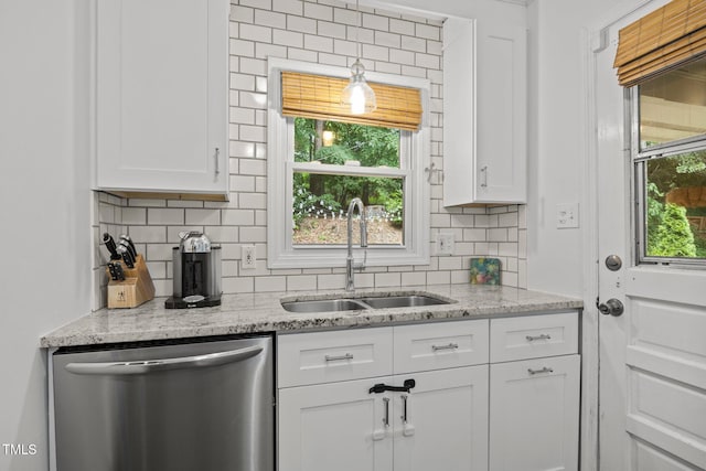 926 Wimbleton Dr, Raleigh, NC 27609 - kitchen with stainless steel dishwasher, white cabinetry, backsplash, and light stone counters