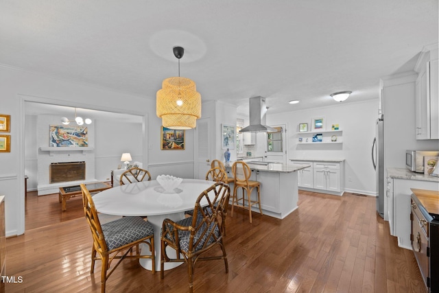 926 Wimbleton Dr, Raleigh, NC 27609 - dining room with hardwood / wood-style floors, crown molding, and a fireplace