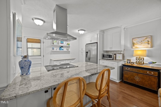 926 Wimbleton Dr, Raleigh, NC 27609 - kitchen featuring appliances with stainless steel finishes, island range hood, a breakfast bar, white cabinetry, and dark wood finished floors