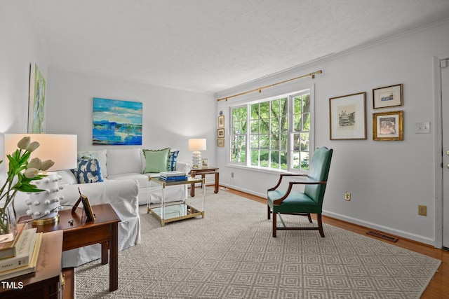 926 Wimbleton Dr, Raleigh, NC 27609 - living room featuring crown molding, wood finished floors, and a textured ceiling