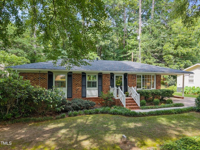 926 Wimbleton Dr, Raleigh, NC 27609 - single story home with brick siding, a front lawn, and roof with shingles