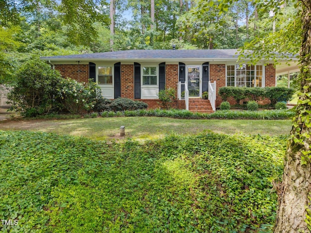 926 Wimbleton Dr, Raleigh, NC 27609 - ranch-style house with brick siding and a front yard