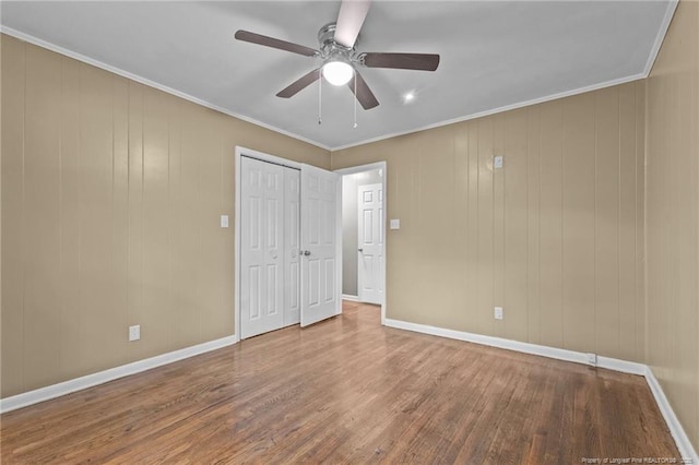 425 N Platte Rd, Fayetteville, NC 28303 - unfurnished bedroom with wood finished floors, crown molding, a closet, and a ceiling fan