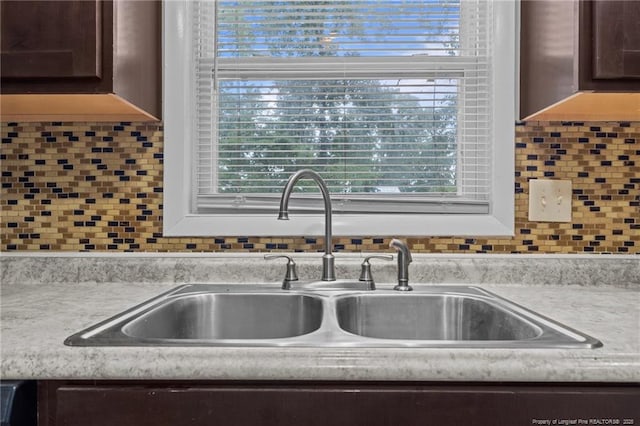425 N Platte Rd, Fayetteville, NC 28303 - kitchen view of dark brown cabinetry, light countertops, and backsplash