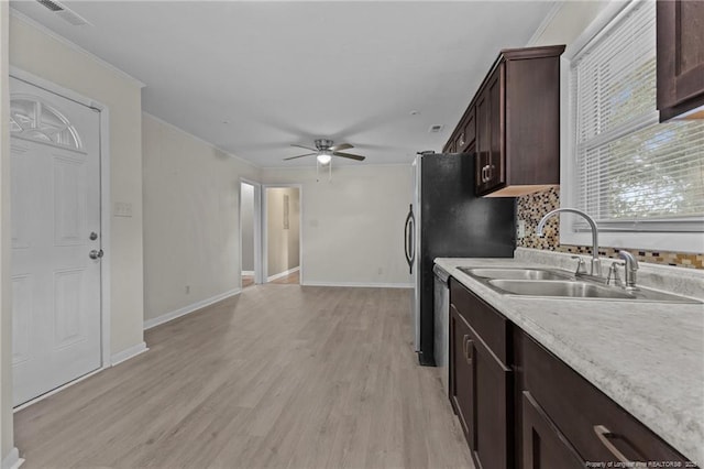 425 N Platte Rd, Fayetteville, NC 28303 - kitchen featuring dark brown cabinetry, a ceiling fan, light countertops, light wood-style floors, and crown molding