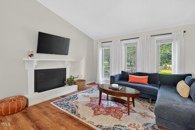 810 Royal Oaks Dr, Durham, NC 27712 - living room featuring wood finished floors, lofted ceiling, and a fireplace