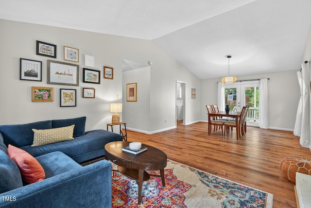 810 Royal Oaks Dr, Durham, NC 27712 - living area featuring wood finished floors and vaulted ceiling