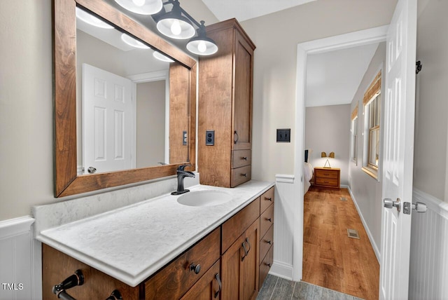 810 Royal Oaks Dr, Durham, NC 27712 - bathroom with vanity, wood finished floors, and wainscoting