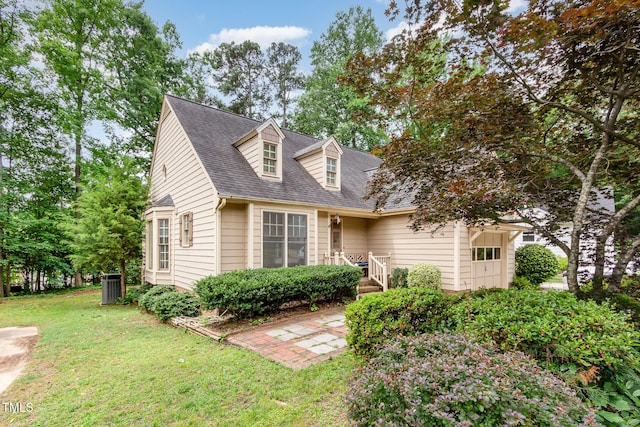 1408 Morningsdale Dr, Raleigh, NC 27609 - cape cod-style house featuring a front yard, roof with shingles, and an attached garage