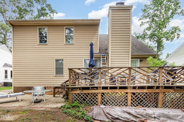 1408 Morningsdale Dr, Raleigh, NC 27609 - back of house featuring a deck, a chimney, a patio area, and a shingled roof