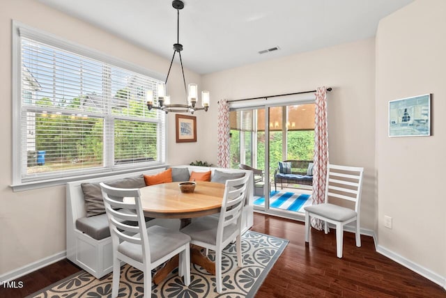 1924 Rustica Dr, Durham, NC 27713 - dining room featuring dark wood-type flooring, a chandelier, and breakfast area