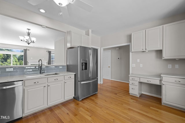 400 Nottinghill Walk, Apex, NC 27502 - kitchen with stainless steel appliances, white cabinets, tasteful backsplash, and light wood-type flooring