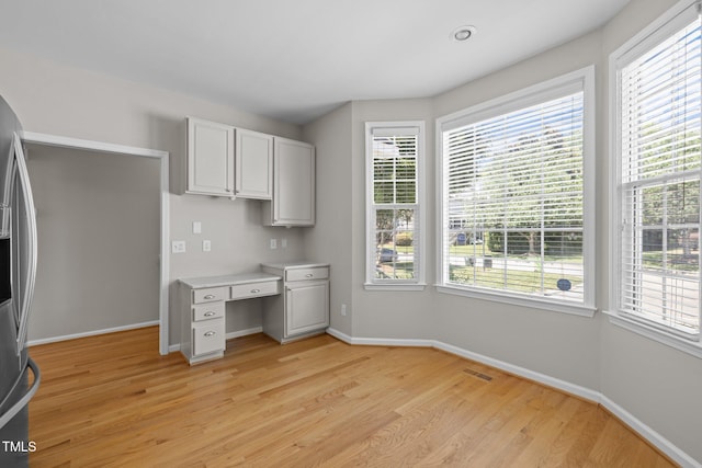 400 Nottinghill Walk, Apex, NC 27502 - kitchen featuring light wood finished floors, healthy amount of natural light, and stainless steel fridge with ice dispenser