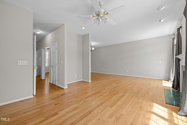 400 Nottinghill Walk, Apex, NC 27502 - unfurnished living room featuring a ceiling fan, light wood-style flooring, a fireplace, and recessed lighting