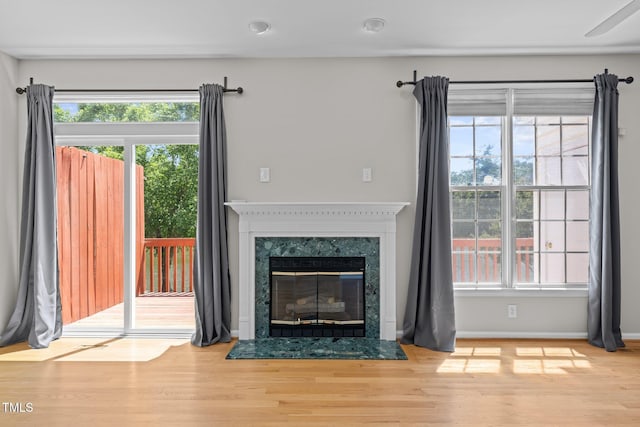 400 Nottinghill Walk, Apex, NC 27502 - unfurnished living room with wood finished floors, healthy amount of natural light, a high end fireplace, and recessed lighting