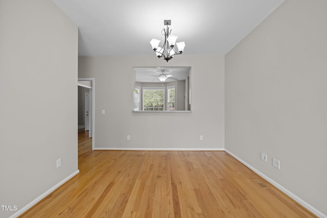 400 Nottinghill Walk, Apex, NC 27502 - unfurnished room with a chandelier, wood finished floors, and a ceiling fan