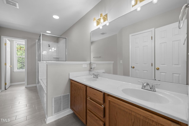 400 Nottinghill Walk, Apex, NC 27502 - bathroom featuring an enclosed shower, double vanity, recessed lighting, and wood finished floors