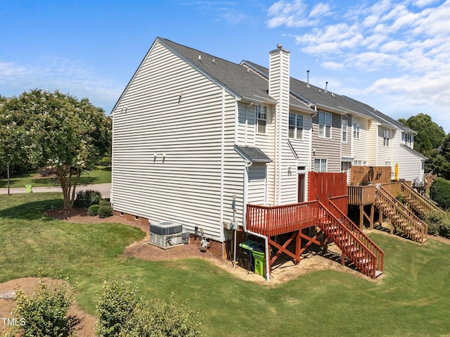 400 Nottinghill Walk, Apex, NC 27502 - back of property featuring a chimney, a deck, stairs, and a lawn