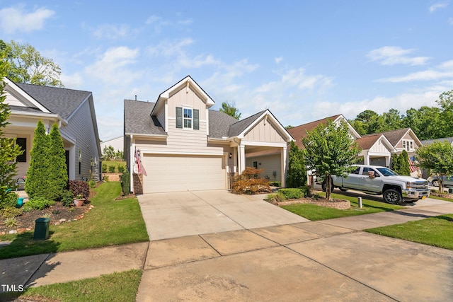 1019 Santiago St, Durham, NC 27703 - view of front facade featuring board and batten siding, driveway, a front lawn, a garage, and brick siding