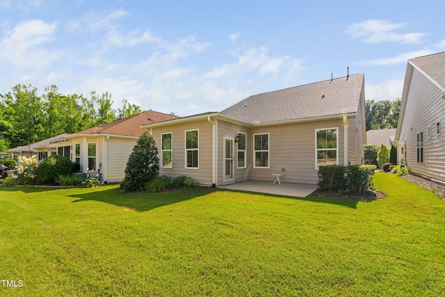 1019 Santiago St, Durham, NC 27703 - back of property with a patio and a lawn