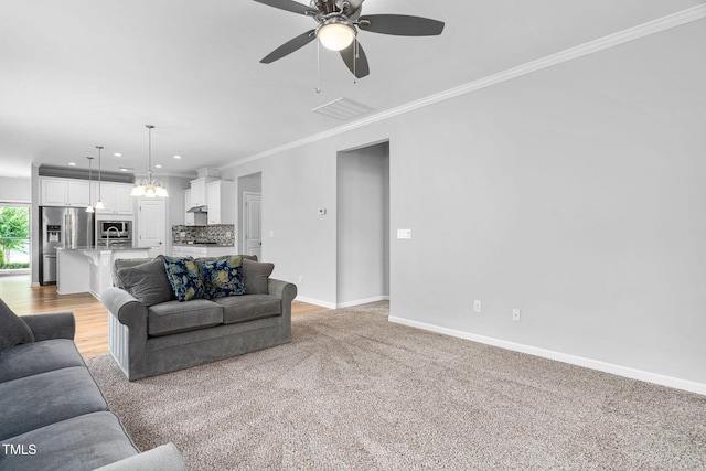 1019 Santiago St, Durham, NC 27703 - living room featuring recessed lighting, crown molding, a ceiling fan, light carpet, and a chandelier
