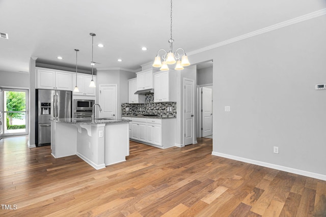 1019 Santiago St, Durham, NC 27703 - kitchen with appliances with stainless steel finishes, backsplash, crown molding, a chandelier, and white cabinets